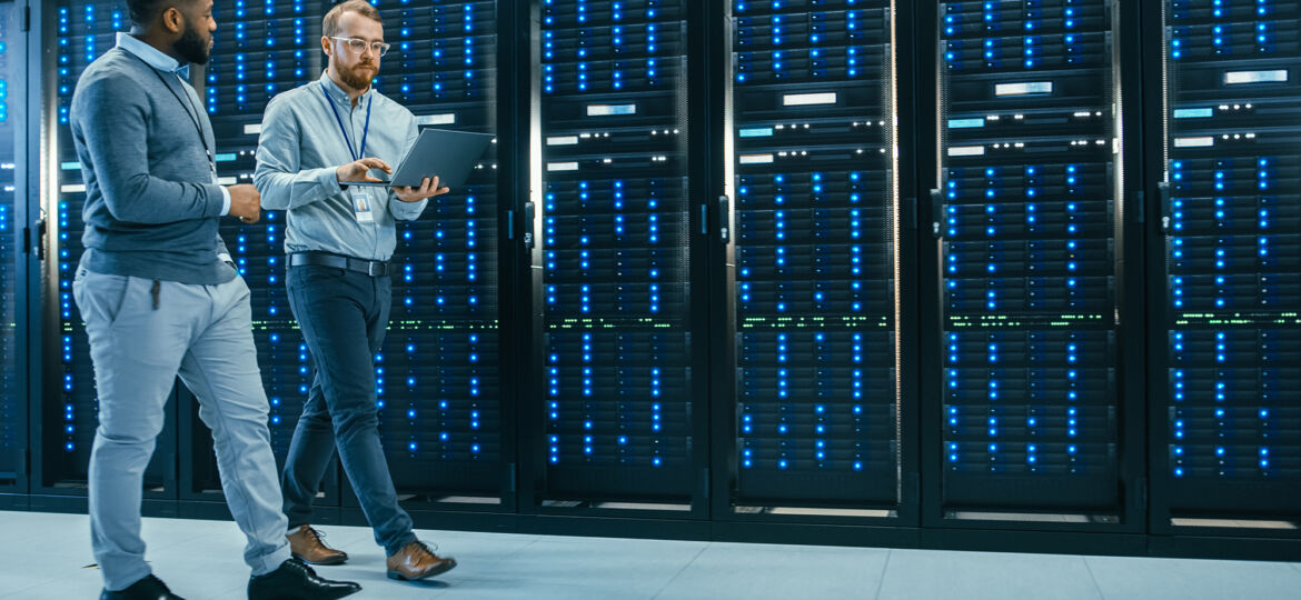 IT Technician with a Laptop Computer and Black Male Engineer Col